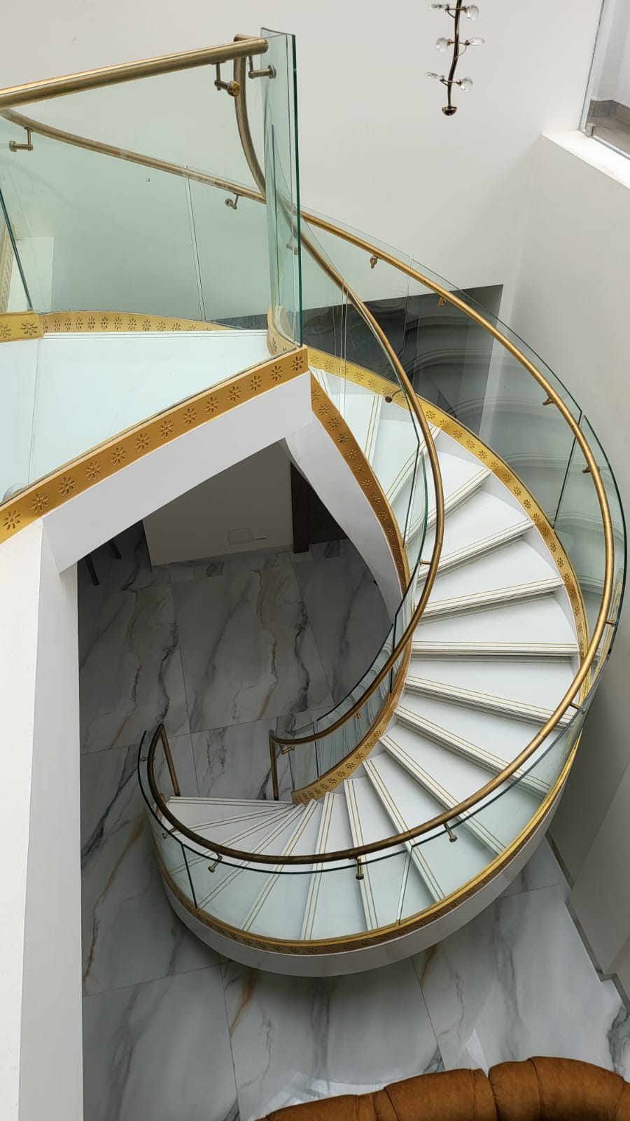 White marble-finish helical steel staircase in Chennai, Tamil Nadu